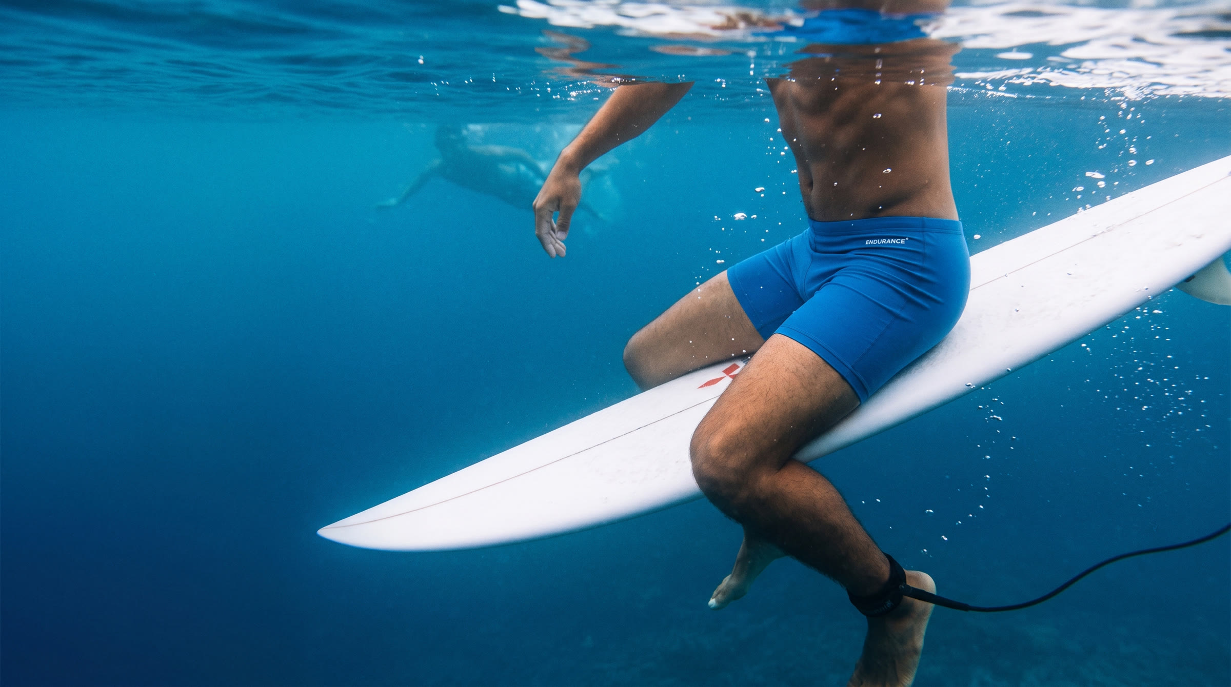 Swimmer resting on a board below the surface